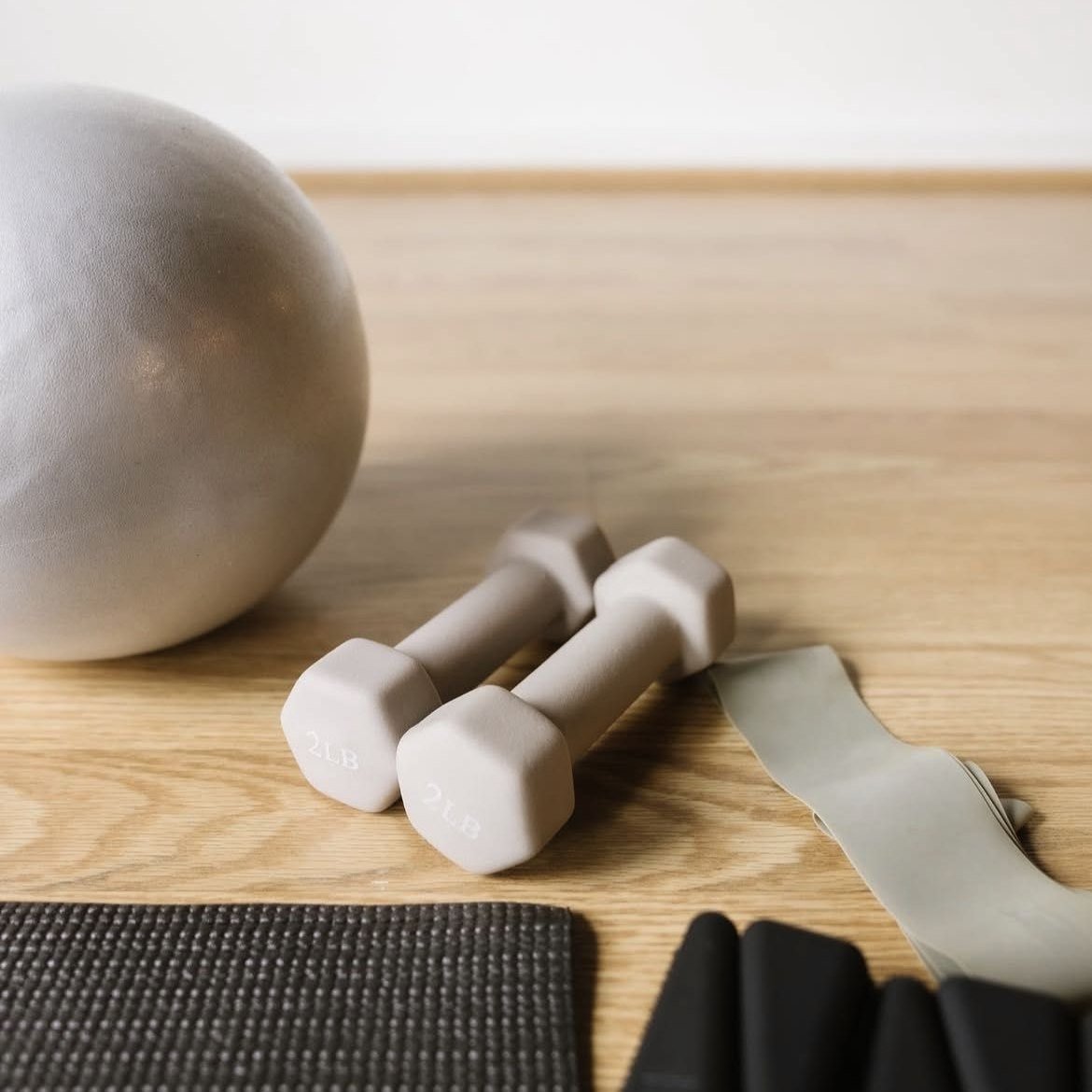 Dumbbells and an exercise ball on the studio floor