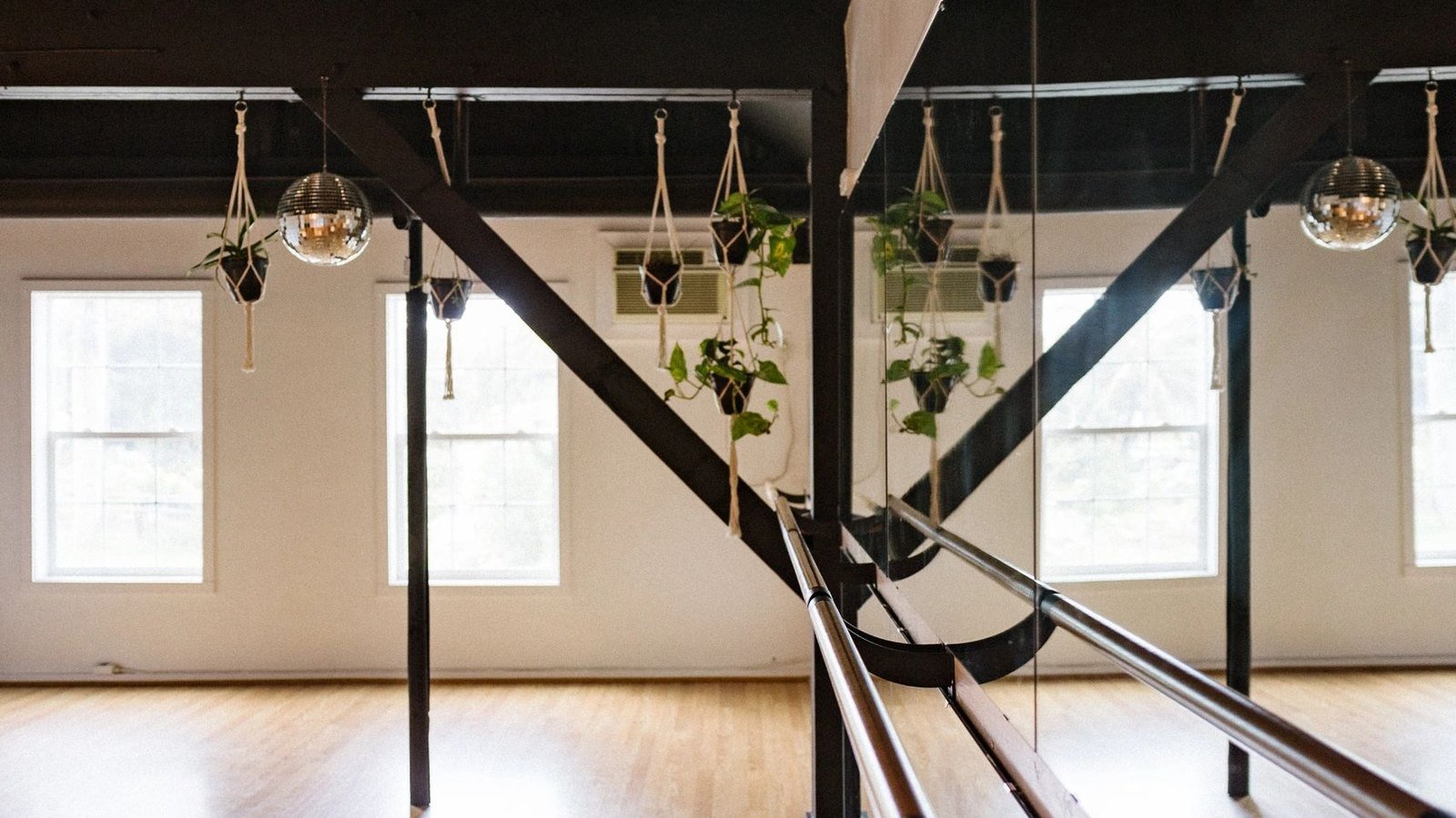 The Th3 Loft studio with tall windows and hanging plants